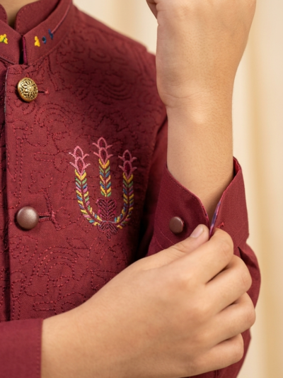 Al Fajar boys maroon waistcoat with all-over tonal scroll embroidery, mandarin collar with multicolour embroidered accents, festive kids ethnic wear.